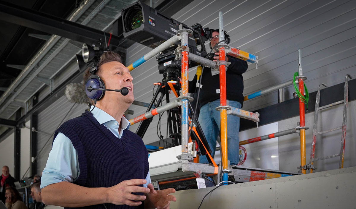 Basti Schwele beim Kommentar, im Hintergrund die zentrale Kameraposition.